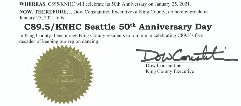 An image of part of an official proclamation. A round, gold seal is at the bottom left and next to it is the signature of Dow Constantine, King County Executive