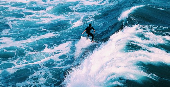 man surfing on ocean