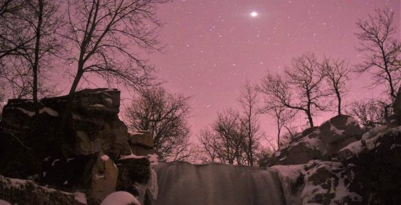 "Winnewissa Under Stars" (Winnewissa surrounded by a dusting of snow on the cliffs and a blanket of stars overhead). Credit: Pipestone National Monument (National Park Service), public domain.