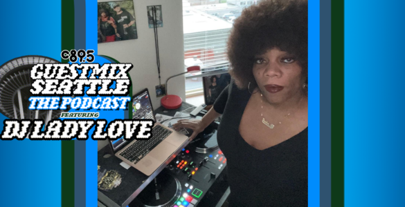 Woman standing at a DJ station with a microphone and laptop, displaying a music software interface. A large round logo with text: "Guest Mix Seattle The Podcast DJ Lady Love" overlays part of the image. There are framed pictures in the background and an interior setting is visible.