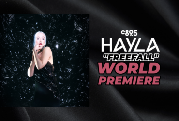 Promotional banner featuring the artist Hayla at the world premiere of "Freefall," highlighted by the C895 logo, set against a sleek, dark background with shimmering textures.