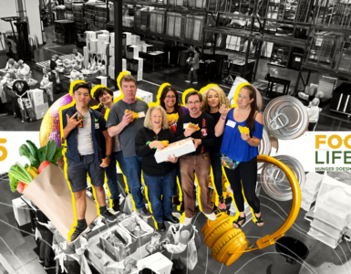 Group of volunteers at Food Lifeline, smiling and posing in a warehouse setting surrounded by boxes and canned goods, with a banner displaying gratitude and statistics about volunteer efforts.