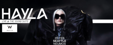 Promotional banner featuring the artist HAYLA, announced to perform live at The Sound Suite, W Seattle, on February 22 at Neumos. The image shows HAYLA wearing a large black outfit and sunglasses, set against a dark background.